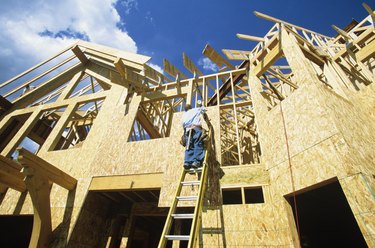 Man working at new home construction, low angle view