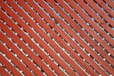 Pattern of wooden slats in chainlink fence