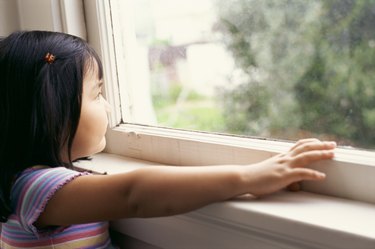 Girl looking out window