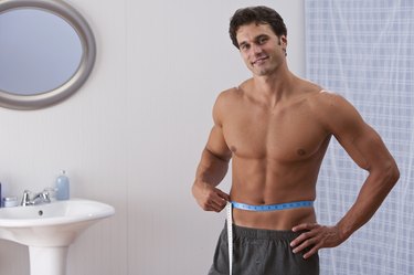 man mesuring waistline