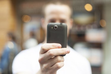 Men photographing with mobile phone