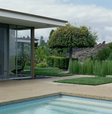 Swimming pool and landscaped yard alongside modern home