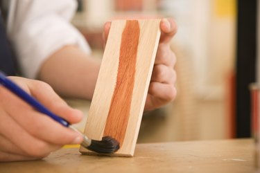 Hands staining wood