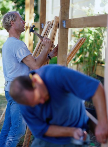 Carpenters Building a Fence
