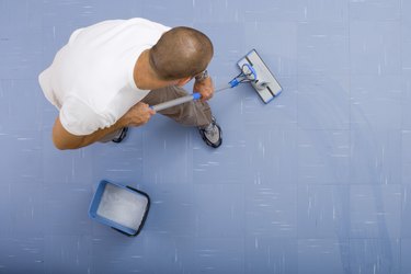 High angle view of man mopping floor