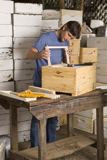 Man building beehives