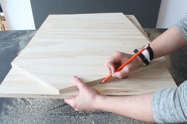 Tracing cut lines on second piece of plywood