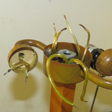 Disassembled lamp with unconnected wires.