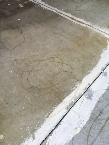 Concrete floor with white around the cracks.