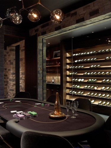 Stone wine room located in game room of a home
