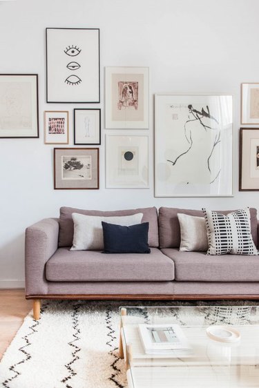 living room with gallery wall and blush pink sofa