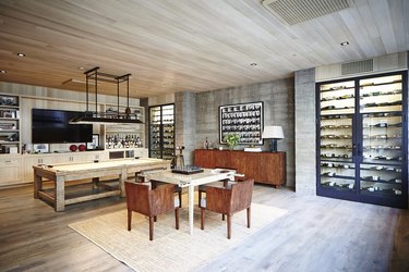 Sophisticated adult game room featuring two wine walls, bar area, and games