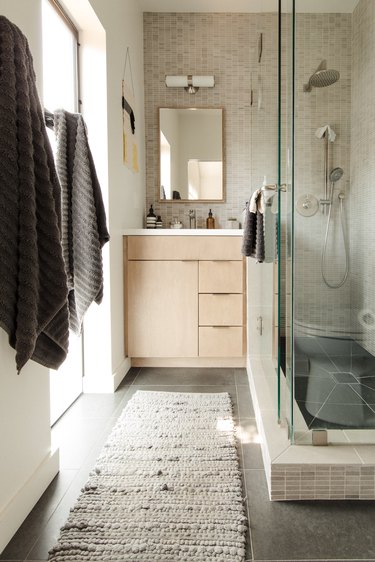 small modern bathroom with tiled wall and shower