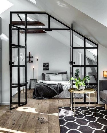 small bedroom with glass door and partition