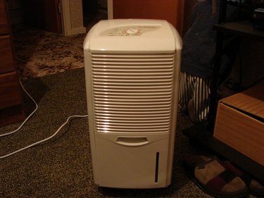 Air purifier in cluttered room.