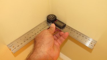 A digital protractor being used on an inside corner.