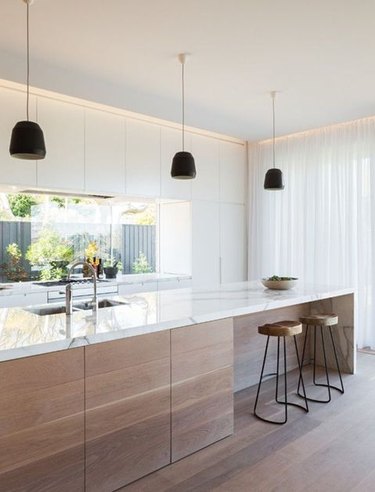 white modern kitchen with light wood island
