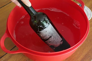 Soak the wine bottle in the soapy water for 15-20 minutes.