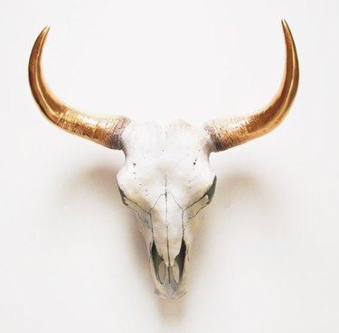 faux animal skull with gold horns