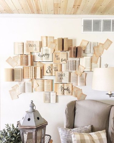 Books with words on them taped to the wall.