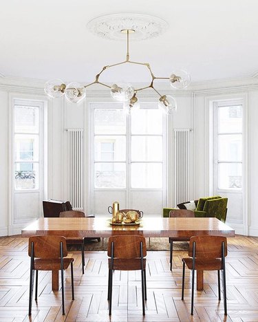 Minimal wood-dominated dining room with sputnik chandelier