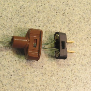 Lamp cord attached to disassembled cord plug.