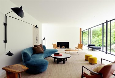 living room with curved sofa and round coffee table