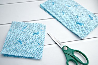 Cut the reusable cloth wipes in half.