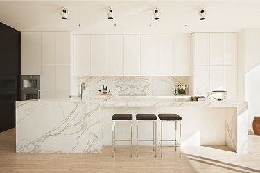white modern kitchen with marble island and backsplash