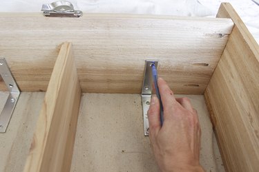 Attaching L backet to inside of box frame.