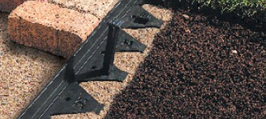 Brick paver with plastic edge.