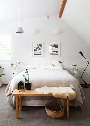 White midcentury bedroom with twin wall sconces above the bed