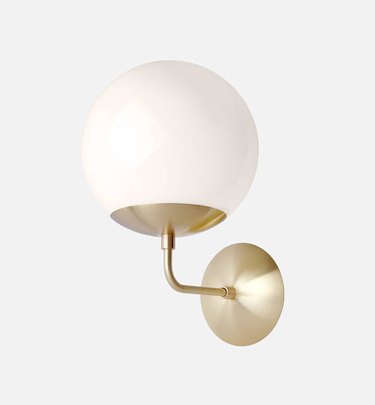 Globe wall sconce with brass finish