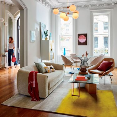 Colorful living room featuring lots of rounded furniture