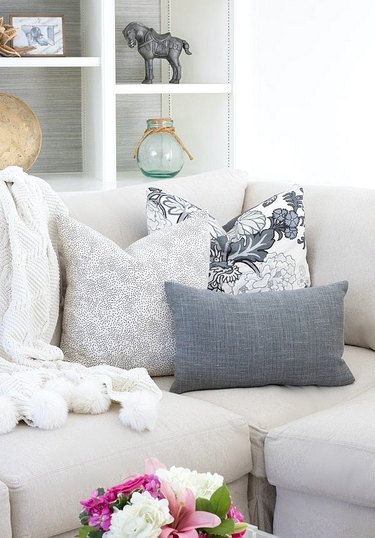 three denim and white throw pillows in varying shapes and sizes