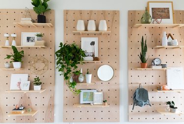 pegboard shelves with plants and pictures