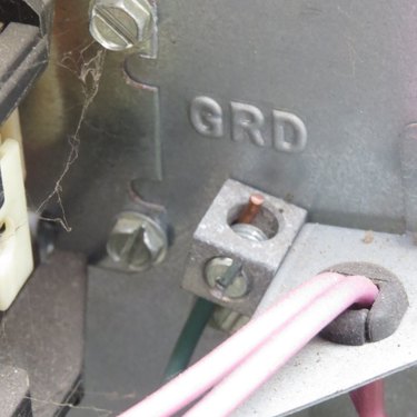 Green ground wire in a ground screw terminal.