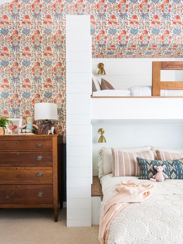 little kids bedroom with floral wallpaper and bunk beds