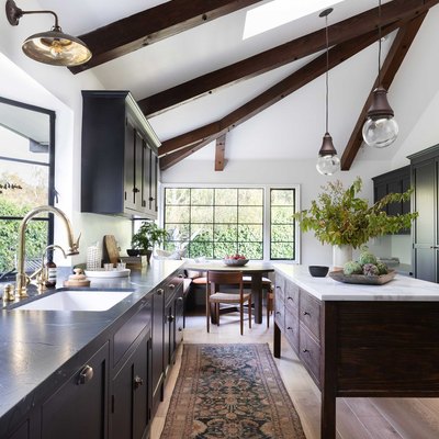 espresso kitchen island with white countertop and dark cabinets