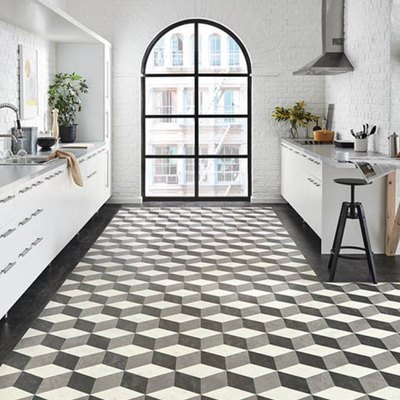Three dimensional stepped pattern tile floor in a white modern kitchen with large picture window.