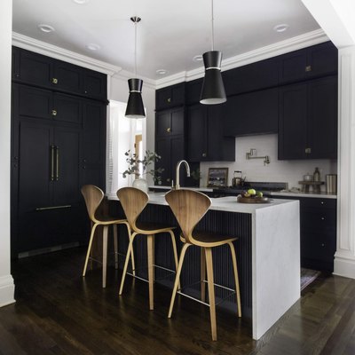 Dark wood kitchen flooring idea with modern bar stools and black cabinets