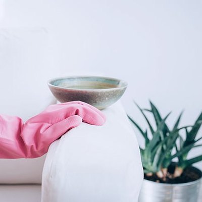 Pink glove wiping couch