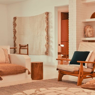 living room in neutral tones with couch and chair