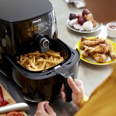 Black air fryer with fries in basket