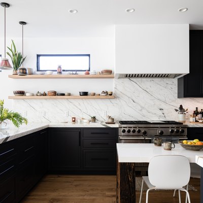 large kitchen with veined marble countertops and backsplash