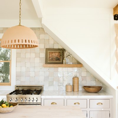 kitchen with pale wood accents, rustic tile and white quartz countertop