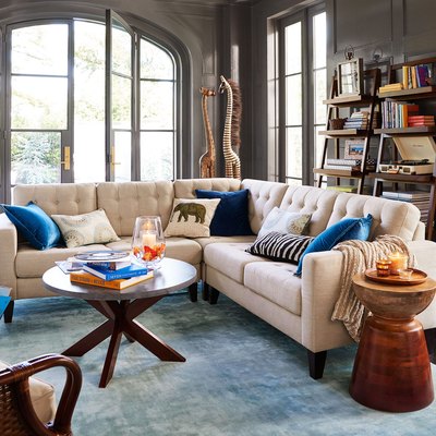 gray living room with white sofa and blue accent pillows