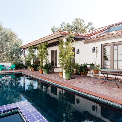 Spanish backyard pool design with terracotta and patterned tiles