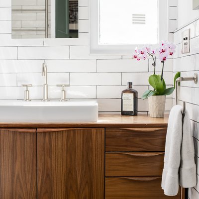freestanding bathroom vanity and sink with subway tile wall tiles