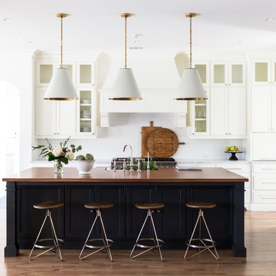 kitchen space with stools and hanging light fixtures